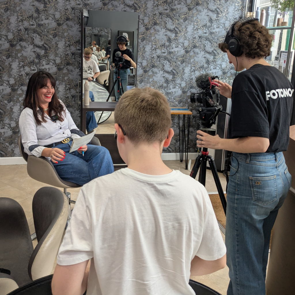 Hairdresser being filmed in a salon