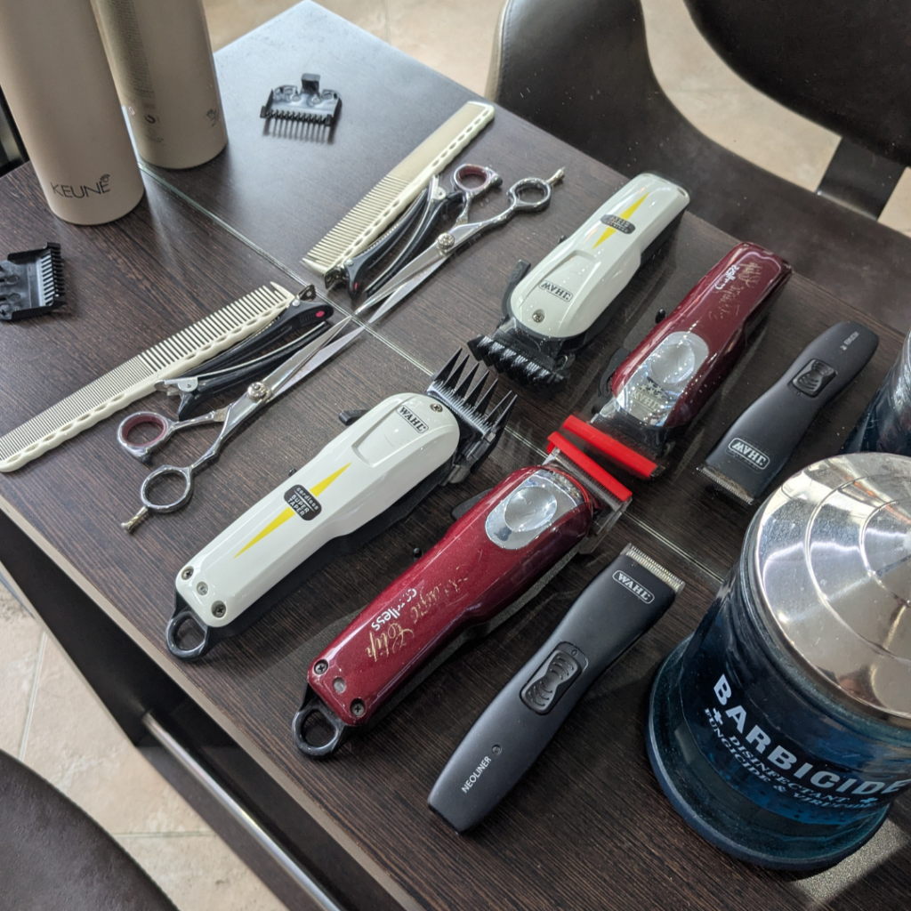 Clippers and scissors all presented on a table at a hairdressers